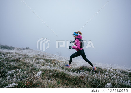 Trail Runner in Misty Mountain Landscape 128680976