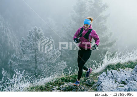 Trail Runner in Misty Mountain Landscape Trail Runner in Misty Mountain Landscape 128680980