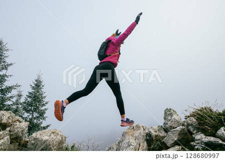 Trail Runner in Misty Mountain Landscape Trail Runner in Misty Mountain Landscape 128680997