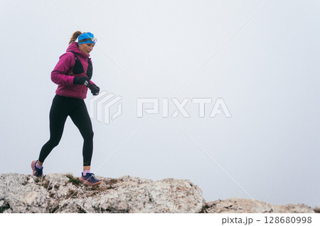 Trail Runner in Misty Mountain Landscape Trail Runner in Misty Mountain Landscape 128680998