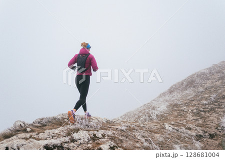 Trail Runner in Misty Mountain Landscape Trail Runner in Misty Mountain Landscape 128681004