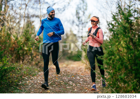 Happy Couple Running on a Forest Trail 128681034