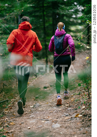 Happy Couple Running on a Forest Trail 128681036