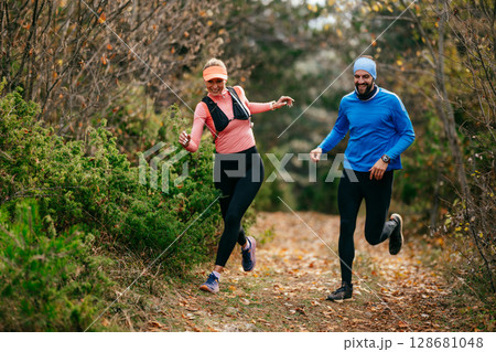 Happy Couple Running on a Forest Trail 128681048
