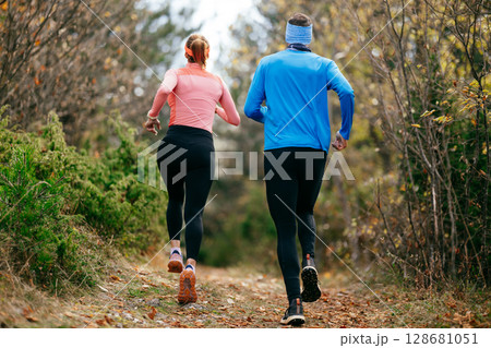 Happy Couple Running on a Forest Trail 128681051