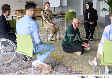 Corporate business team meeting with a manager or coach. Group of happy diverse, multiracial people sitting in a circle  128681129