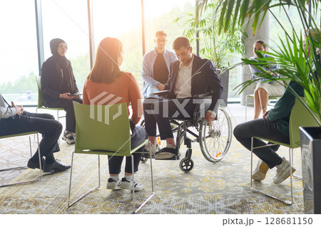 Corporate business team meeting with a manager or coach. Group of happy diverse, multiracial people sitting in a circle Corporate business team meeting with a manager or coach. Group of happy diverse, multiracial people sitting in a circle 128681150