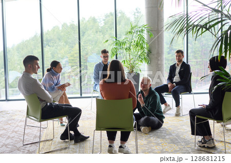 Corporate business team meeting with a manager or coach. Group of happy diverse, multiracial people sitting in a circle Corporate business team meeting with a manager or coach. Group of happy diverse, multiracial people sitting in a circle 128681215