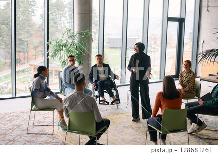 Corporate business team meeting with a manager or coach. Group of happy diverse, multiracial people sitting in a circle Corporate business team meeting with a manager or coach. Group of happy diverse, multiracial people sitting in a circle 128681261