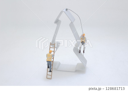 Miniature Workers Decorating a Tree-Shaped Object in a Studio Setting Miniature Workers Decorating a Tree-Shaped Object in a Studio Setting 128681713