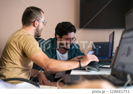 Collaborative Minds: A Team of Programmers Tackling Challenges Together in the Office. 128681751