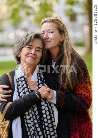 A Heartfelt Embrace: A Daughters Support for Her Mother on a Beautiful Autumn Day. A Heartfelt Embrace: A Daughters Support for Her Mother on a Beautiful Autumn Day. 128681828