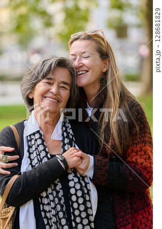 A Heartfelt Embrace: A Daughters Support for Her Mother on a Beautiful Autumn Day. A Heartfelt Embrace: A Daughters Support for Her Mother on a Beautiful Autumn Day. 128681829