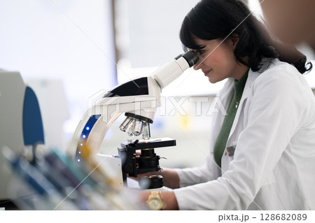 Doctor scientist using microscope in laboratory 128682089
