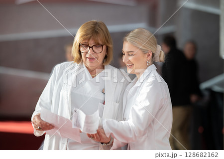 Group of female doctors reviewing medical document 128682162