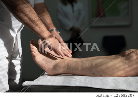 Doctors performing patient diagnostics with equipment Doctors performing patient diagnostics with equipment 128682207