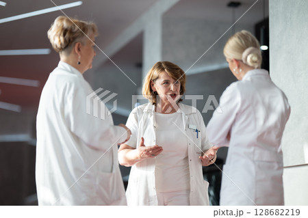 Group of medical professionals having discussion Group of medical professionals having discussion 128682219