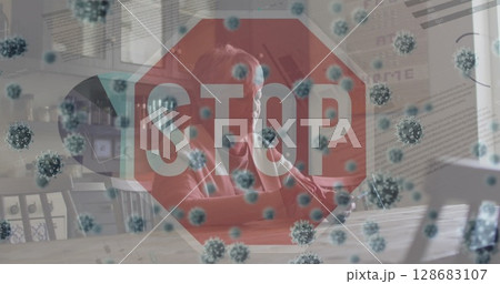 Sitting woman wearing red top gazing outside in kitchen, with stop sign, virus particles and laptop Sitting woman wearing red top gazing outside in kitchen, with stop sign, virus particles and laptop 128683107