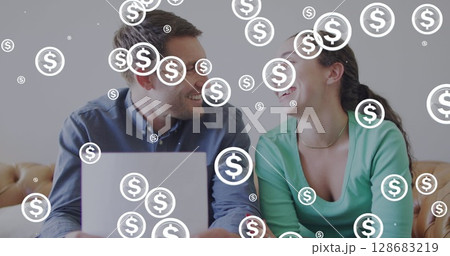 Image of dollar symbols over diverse couple doing paperwork Image of dollar symbols over diverse couple doing paperwork 128683219