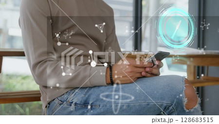 Image of clock moving and shapes over biracial businessman using smartphone 128683515