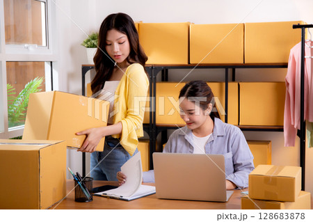 Two young asian businesswoman checking order of customer for laptop computer and document. 128683878