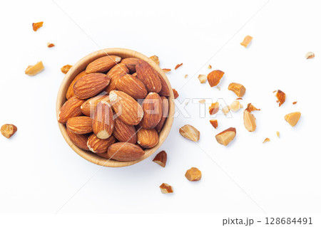 Almond in wood bowl with broken almond nuts isolated on white background 128684491