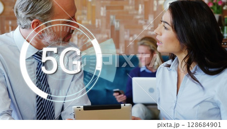 Image of 5g over diverse businessman and businesswoman talking in office Image of 5g over diverse businessman and businesswoman talking in office 128684901