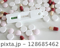 Positive test result of Covid-19 antigen test kit and drugs isolated on the white background 128685462