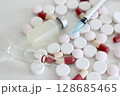 Vial and ampule of drug, 1 ml plastic syringe with needle, drug tablet and capsule isolated on the white background 128685465