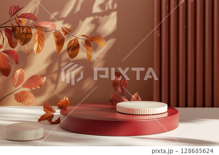 Minimal autumn-themed product podium with warm light and orange leaves. background for cosmetics or branding display. 128685624