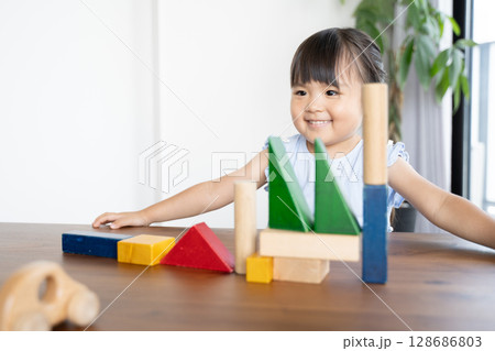 積み木で遊ぶ幼い女の子の知育風景 128686803