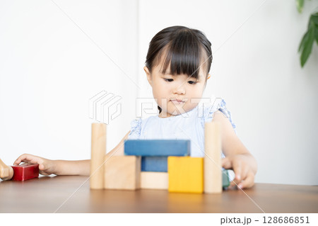 積み木で遊ぶ幼い女の子の知育風景 積み木で遊ぶ幼い女の子の知育風景 128686851