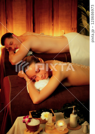 Couple customer having exfoliation treatment in luxury spa. Quiescent 128686973