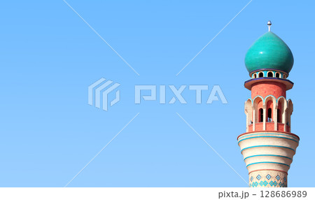 Horizontal banner with minaret of Friday Mosque against a blue sky backdrop, Ardabil, Iran. Topic of vacation, travel, trip abroad on vacation, cruises and tours. Copy space for text Horizontal banner with minaret of Friday Mosque against a blue sky backdrop, Ardabil, Iran. Topic of vacation, travel, trip abroad on vacation, cruises and tours. Copy space for text 128686989