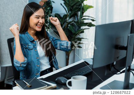 Successful Asian freelancer getting creative project on website. Stratagem. Successful Asian freelancer getting creative project on website. Stratagem. 128687022