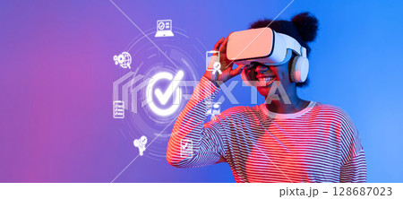 Woman Wearing Virtual Reality Headset with Digital Interface and Quality Control Icons for Technology in Modern Management System XDMCP Woman Wearing Virtual Reality Headset with Digital Interface and Quality Control Icons for Technology in Modern Management System XDMCP 128687023