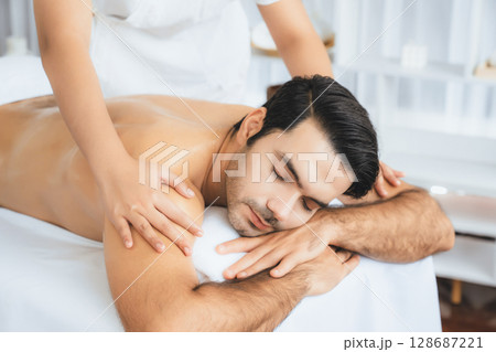 Caucasian man customer enjoying relaxing anti-stress massage. Quiescent Caucasian man customer enjoying relaxing anti-stress massage. Quiescent 128687221