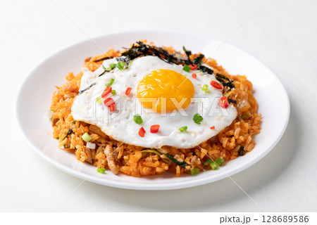 Korean kimchi fried rice with fried egg, pork, sesame seed, chili, spring onion and seaweed Korean kimchi fried rice with fried egg, pork, sesame seed, chili, spring onion and seaweed 128689586