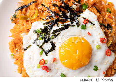Korean kimchi fried rice with fried egg, pork, sesame seed, chili, spring onion and seaweed 128689590