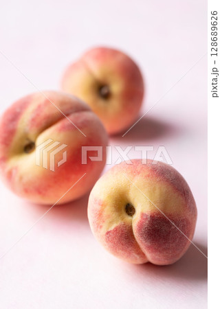 Fresh peaches on pink background, Summer fruit Fresh peaches on pink background, Summer fruit 128689626