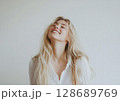 Young happy beautiful woman with long blond hair with cute smile wearing white shirt.AI Generative. 128689769