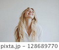 Young happy beautiful woman with long blond hair with cute smile wearing white shirt.AI Generative. 128689770