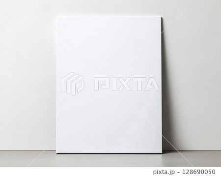 Blank white canvas leaning on wall minimalistic clean art space for creativity 128690050