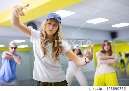 Teen girl in cap dancing modern dances Teen girl in cap dancing modern dances 128690756