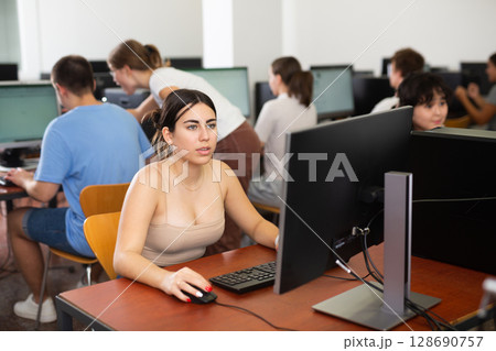 Teenager girl using PC during computer science lesson 128690757