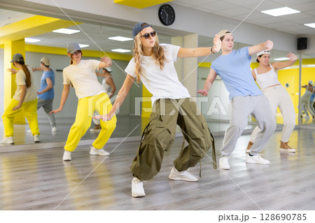 Team of dancers performing hip hop dance in ball room 128690785