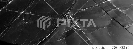 Black aged paper sheets with frayed creases and old worn wrinkles. Abstract dark grunge cardboard poster 128690850