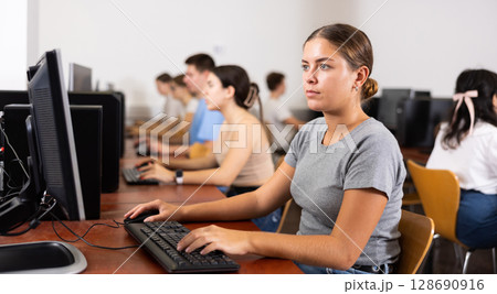 Portrait of young female student studying in computer class Portrait of young female student studying in computer class 128690916