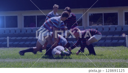 Image of spots lights moving over diverse team of rugby players during game in field Image of spots lights moving over diverse team of rugby players during game in field 128691125