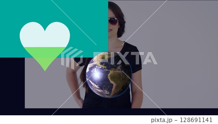 Image of heart and globe over caucasian woman 128691141
